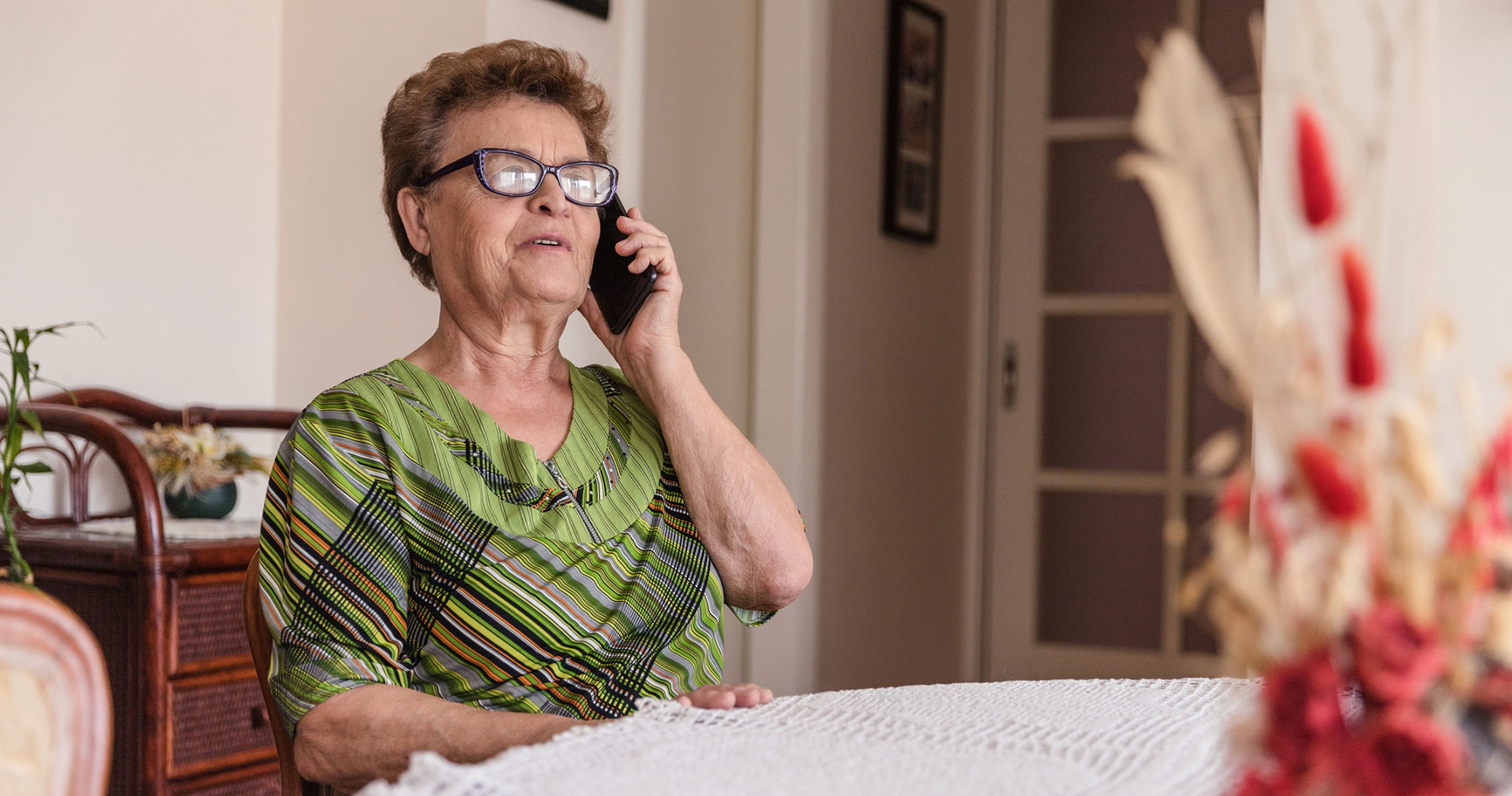 elderly long term care resident answering the phone